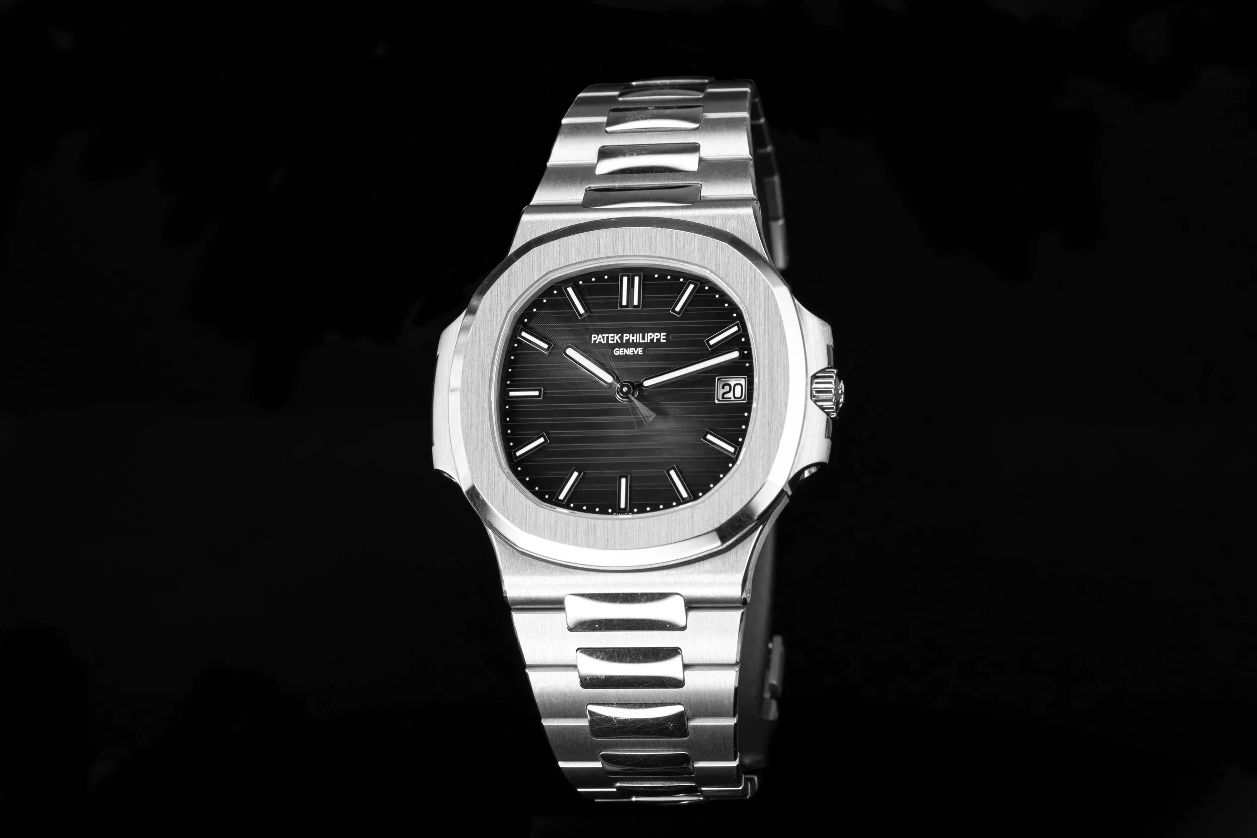 Close-up of a stainless steel Patek Philippe Nautilus with a dark dial